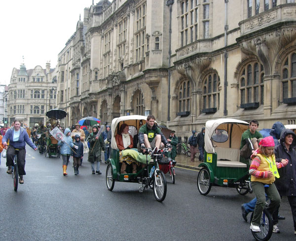 Rickshaws and unicycles pass the Town Hall